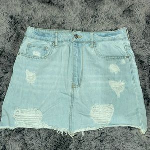 Ligh blue denim skirt with rips